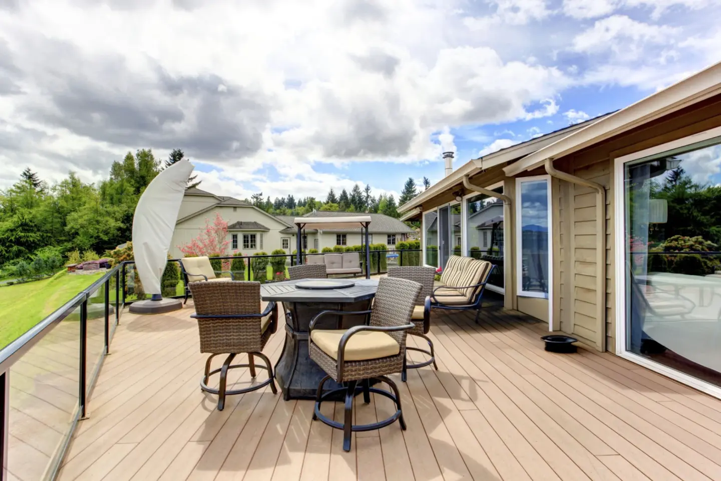 Commercial deck with glass railing and outdoor living furnitures featuring cloudy sky view in miami valley oh