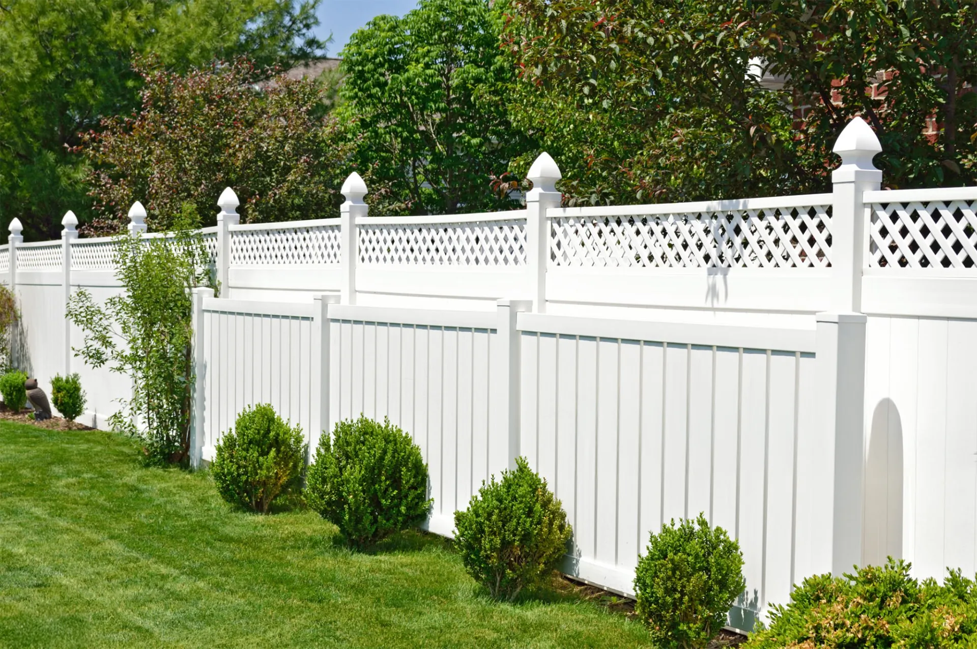 Contemporary white vinyl residential fence with design on top in miami valley oh