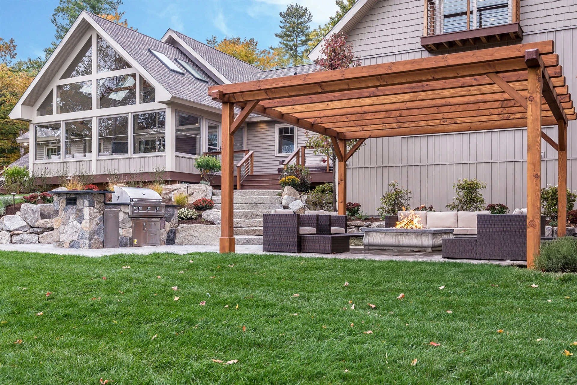 Pergola in back yard outdoor living with fire pit beside the screened in porch in miami valley oh