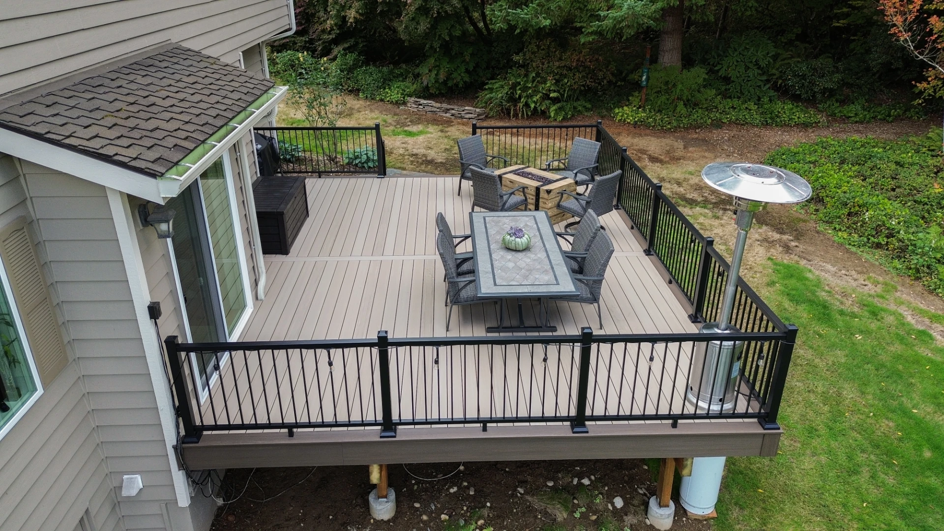 Raised pvc decking installation with outdoor living furniture and firepit in miami valley oh