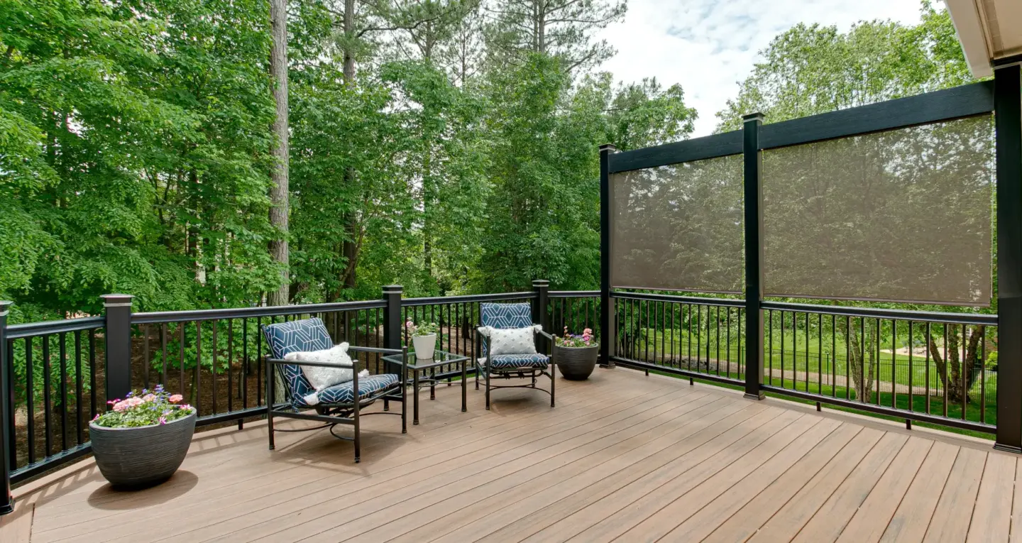 Residential privacy screen on the deck with aluminum railing and outdoor living furniture featuring big trees on the background in miami valley oh
