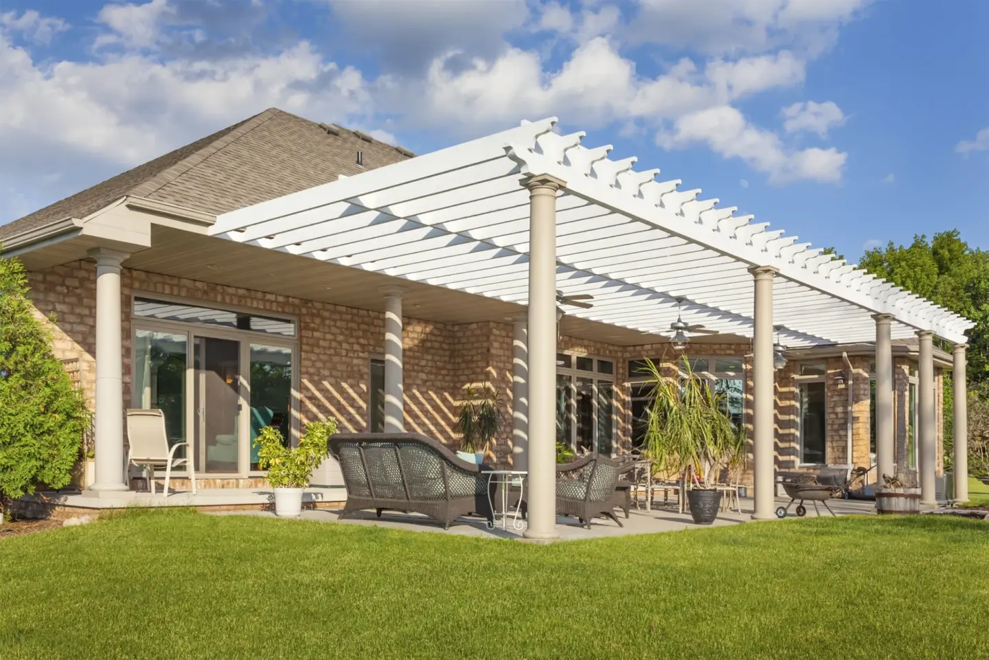 Scenic brick house with large patio and pergola featuring clear sky view in miami valley oh