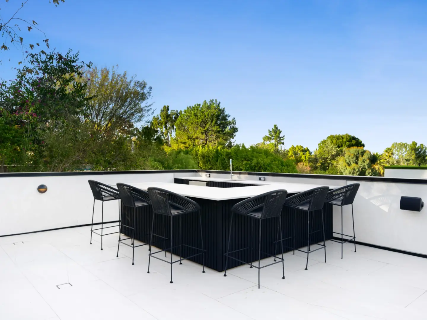 Table placed alongside a building facade featuring clear sky view and big trees in miami valley oh