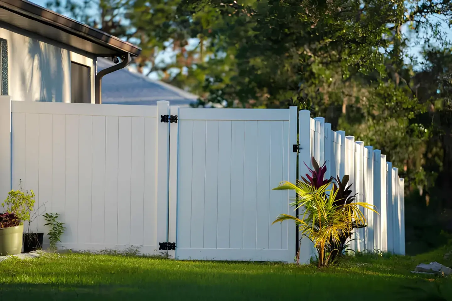 Vinyl white gate picket fence featuring plants and grass view in miami valley oh