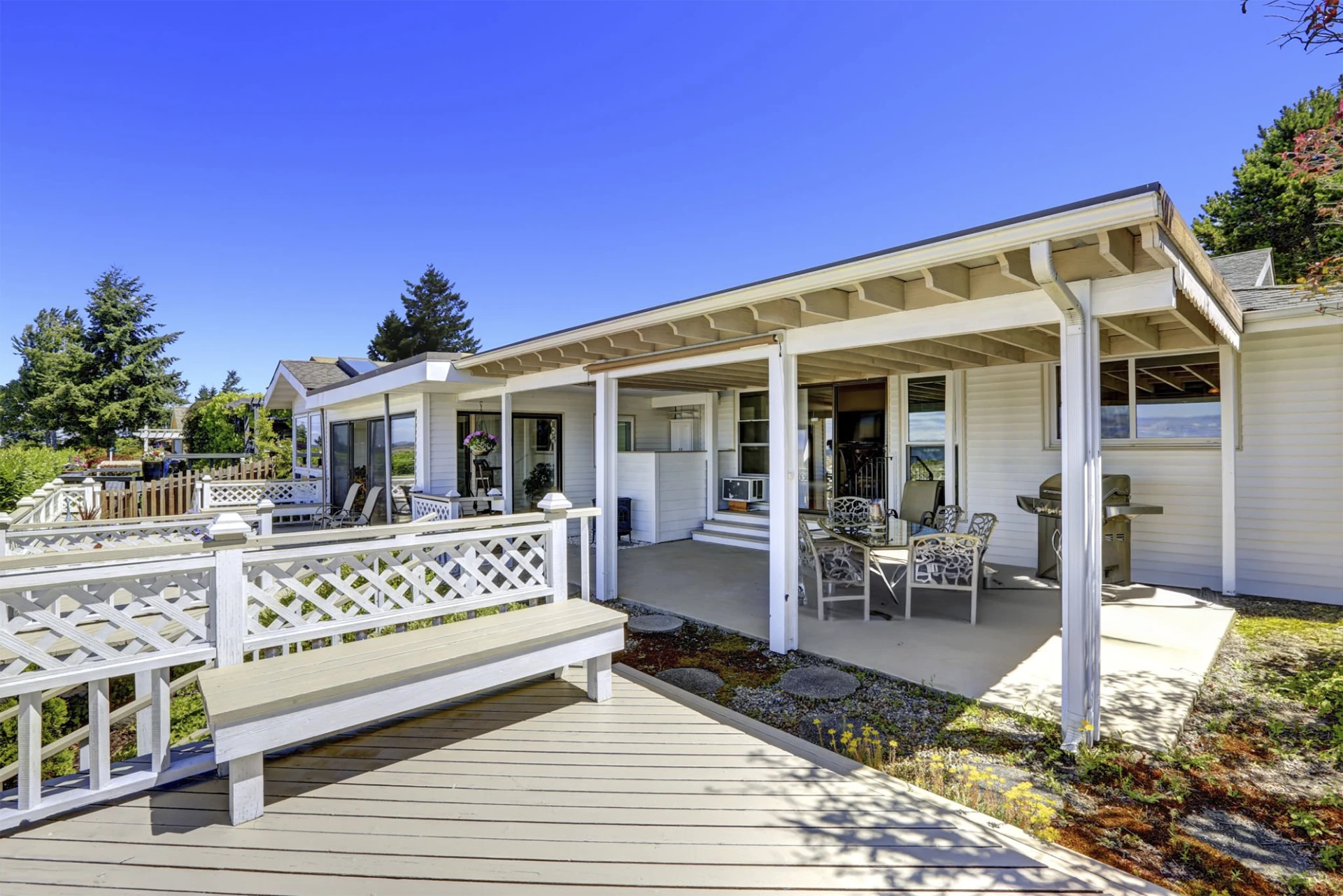 Walkout porch with patio area and wooden bench featuring clear sky view in miami valley oh