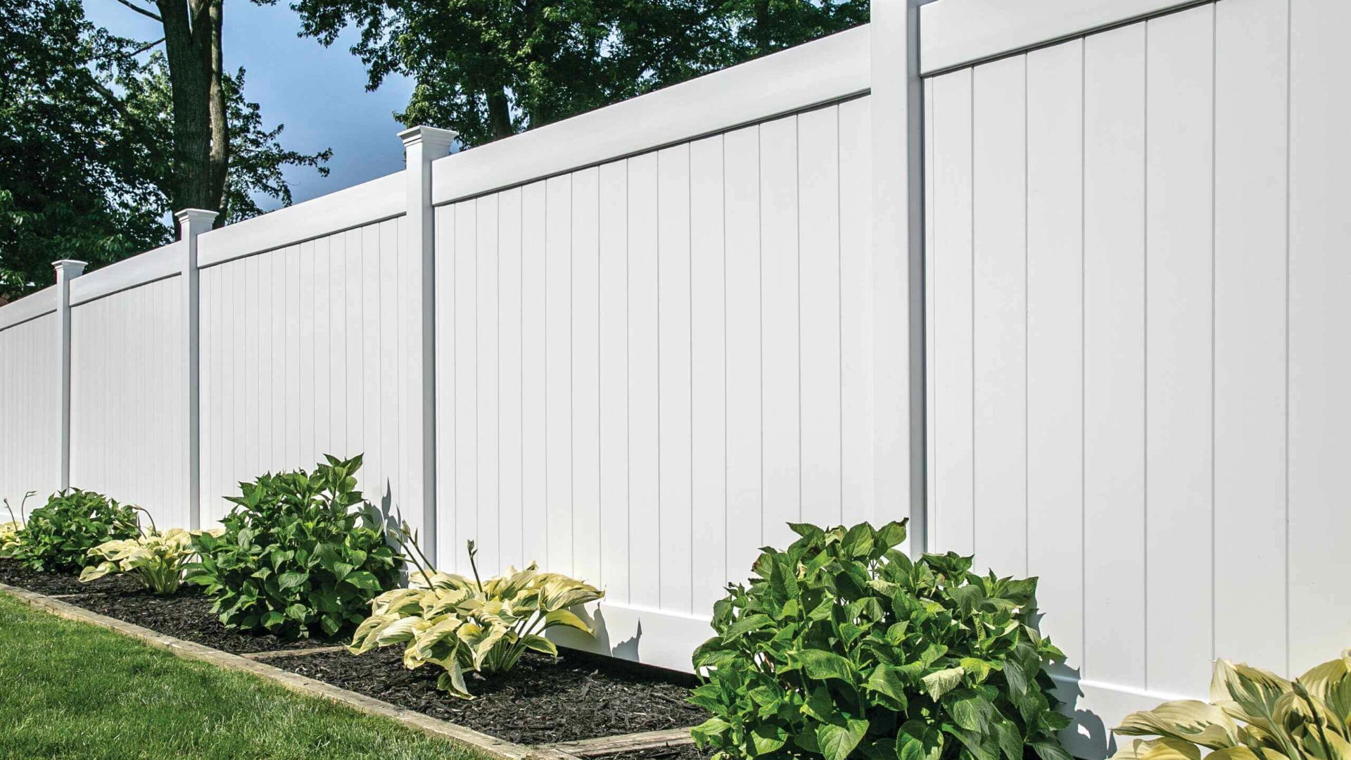 White vinyl composite fence with plants in miami valley oh